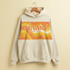 Beige hoodie with retro orange and yellow wave design featuring the NRVANA Social Tonic logo across the chest, hanging on a wooden hanger.